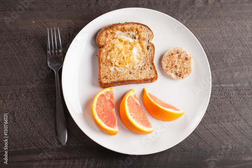 Fotografie, Obraz Toad in a hole egg breakfast with Cara Cara oranges top view
