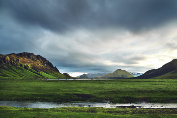 Wall Mural - Travel to Iceland. Beautiful Icelandic landscape with mountains, sky and clouds. Trekking in national park Landmannalaugar. Rainy Evening in Camping near Alftavatn lake.