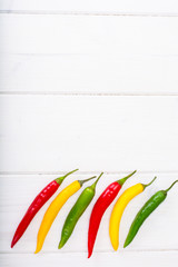 Canvas Print - Chilli peppers on wooden background