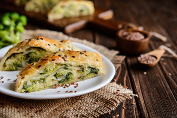 Wall Mural - Savory strudel stuffed with broccoli, Mozzarella cheese and onion