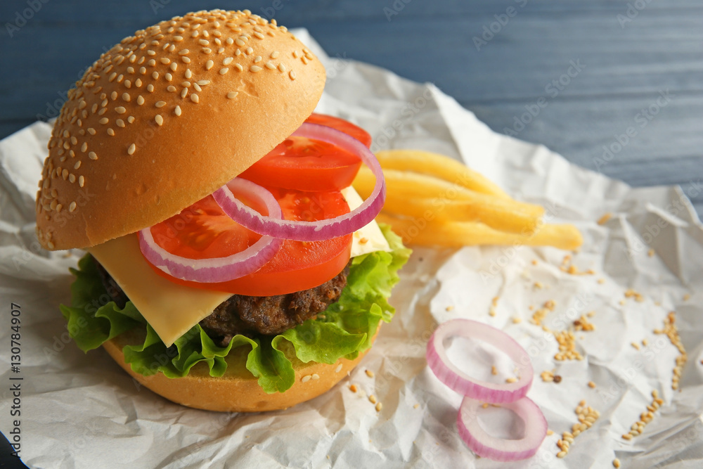 Delicious cheeseburger on paper background