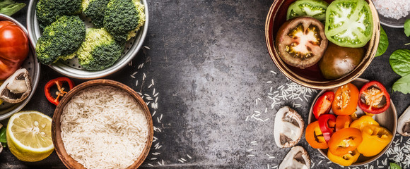 Wall Mural - Rice and vegetables cooking ingredients in bowls on dark rustic background, banner. Healthy and vegetarian food or diet nutrition concept.