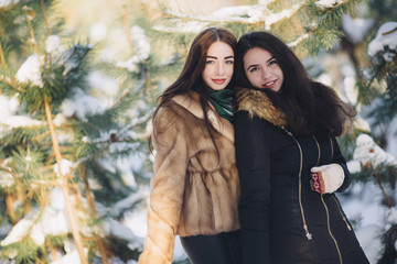 two girls in a snowy forest