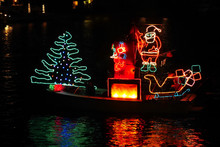There Goes The Merry Christmas Float, Bedecked In Colorful Lights, To Share The Joy Of The Holiday With Santa On His Boat.
