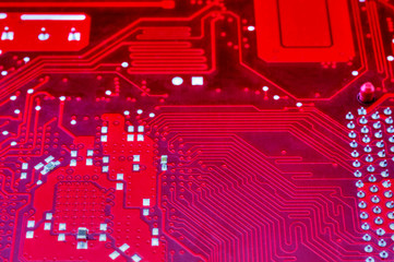 technological background with red computer motherboard closeup