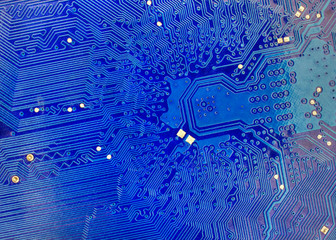 technological background with blue computer motherboard closeup