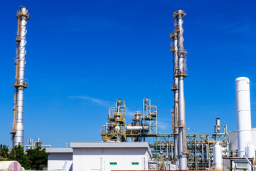 Refinery tower in petrochemical industrial plant with cloudy sky