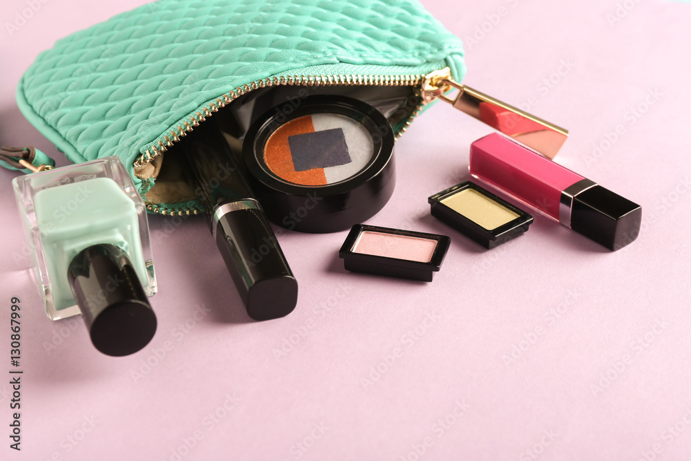 Turquoise make up bag and decorative cosmetics on pink background