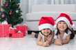 © Tan Kian Khoon - Happy Asian Chinese little sisters celebrate Christmas holiday a
