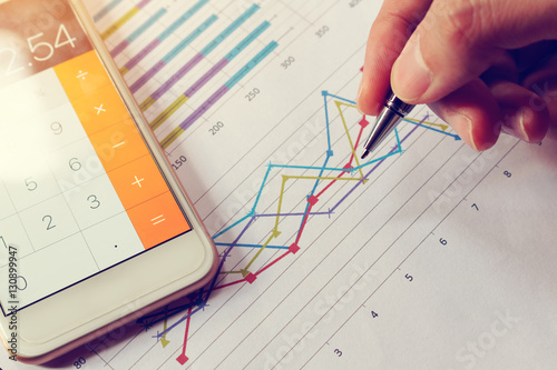 Fotografía Businessman holding pen and think with cost with calculator in s