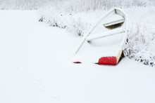 Red Rowboat On The Beach In The Winter