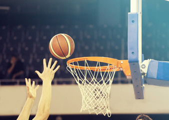 Wall Mural - Ball in hoop at basketball game