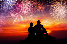 Happy Couple Sitting On Floor And Watching The Fireworks