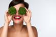 © puhhha - Food For Health. Beautiful Woman Holding Broccoli Before Eyes
