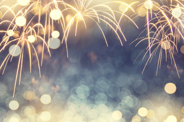 Wall Mural - Gold and green Fireworks and bokeh in New Year eve and copy space. Abstract background holiday.