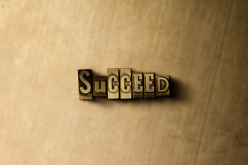 SUCCEED - close-up of grungy vintage typeset word on metal backdrop. Royalty free stock - 3D rendered stock image.  Can be used for online banner ads and direct mail.