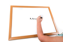 Child Writing On A Dry Erase Board With A Marker