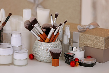 Wall Mural - Set of cosmetics and box with present on white table against blurred background