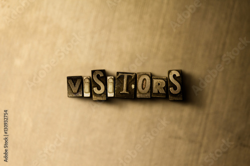 Fotografie, Obraz VISITORS - close-up of grungy vintage typeset word on metal backdrop