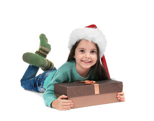 Wall Mural - Cute little girl in Santa hat with Christmas gift on white background