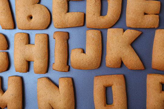 Cookie alphabet on dark background, closeup