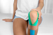 © Africa Studio - Female knee with physio tape, closeup