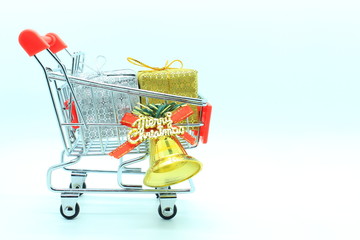 single shopping cart with two gift boxs and golden bell.