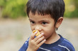 © Suphatthra China - Asian little boy eating crisp rice