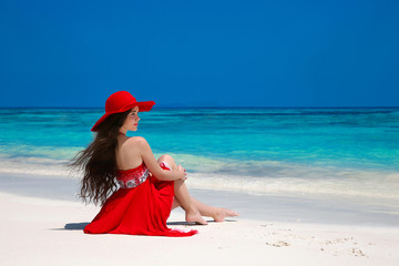 Wall Mural - Beautiful carefree woman in hat enjoying exotic sea, brunette re