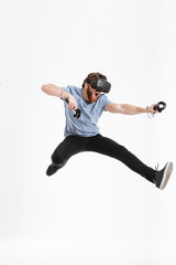 Wall Mural - Bearded screaming man wearing virtual reality device jumping