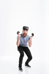 Wall Mural - Young screaming happy man wearing virtual reality device