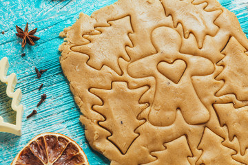 Gingerbread dough with molds for baking cinnamon on blue wooden table