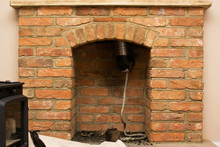 Logburner Installation In Process: Fitting The Woodburner Into The Fireplace, Pipe Sticking Out Of The Chimney, Selective Focus