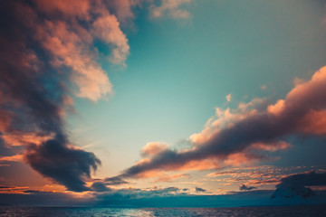 Wall Mural - Summer sunset in Antarctica. Coloured Sunset Clouds over ocean with mountains in the background. Beautiful winter landscape