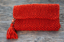 Handmade Knitted Purse On A Wooden Background