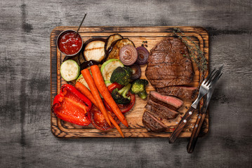 Poster - Cooked grill dish with cut meat on wooden board