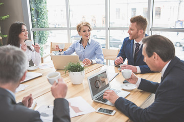 Canvas Print - Happy colleagues are having a conversation