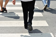 © ZhouEka - People crossing the street on a crosswalk on day time. Safety co