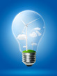 Wind turbine in light bulb with blue background. Clean power plant concept.