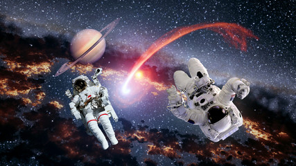 Wall Mural - two astronauts planet saturn spaceman comet space suit galaxy universe. elements of this image furni