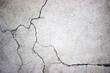 © dmitr1ch - cracked concrete wall covered with gray cement surface as backgr