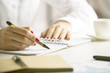 © peshkova - Female writing in notepad