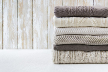 Wall Mural - Stack of warm cozy light sweaters