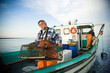 © Richard Schultz - 55+ year old fisherman on boat with a lobster trap.