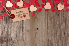 Happy Valentines Day Gift Tag With Scattered Wooden Hearts And Confetti Top Border On A Rustic Wood Background