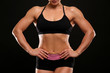 © Africa Studio - Sporty young woman on black background, closeup