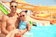 © Africa Studio - Handsome father with little daughter on blurred water slides background