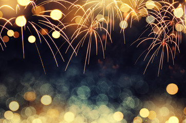 Wall Mural - gold and dark blue fireworks and bokeh in new year eve and copy space. abstract background holiday.