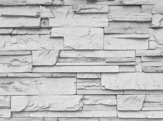 Closeup surface brick pattern at old stone brick wall textured background in black and white tone