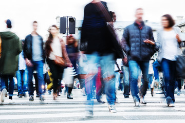 crowds of people crossing a city street